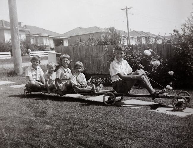 Boy on Billy Cart Towing Four Children on Trailer, Mount Waverley, 1961
