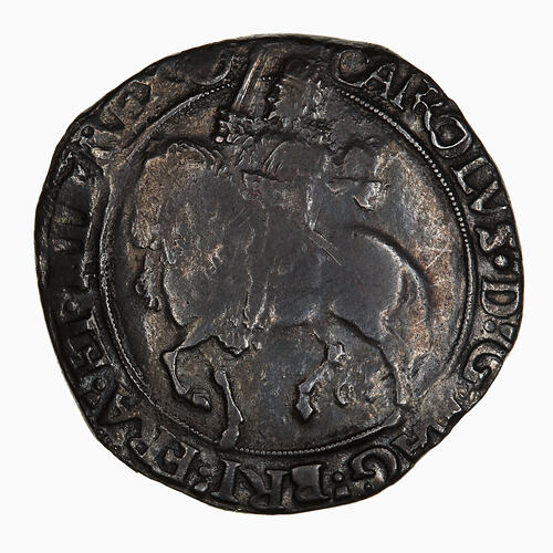Coin, round, at centre within a circle of beads; crowned king wearing long scarf, holding sword near upright.