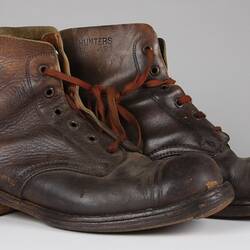 Pair of brown leather lace-up boots, with brown laces.