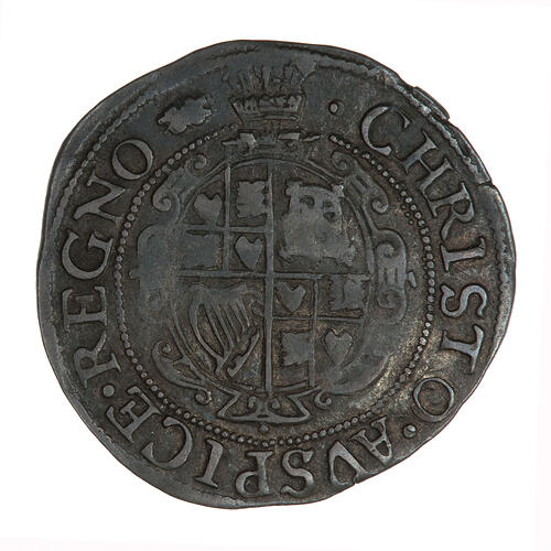 Coin, round, Within an inner beaded circle, a garnished, oval, quartered shield with plume at top.