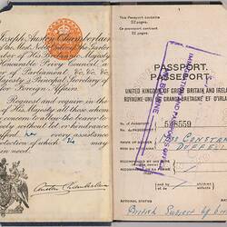 Open passport with two white pages with printed pattern. Printed and and handwritten text. Stamped.