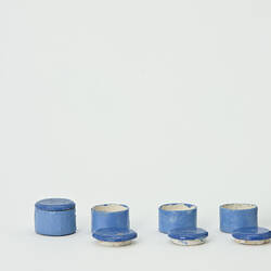 Four blue canisters for a doll's house.
