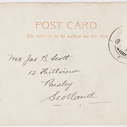 Back of postcard with printed text at top and handwritten text in centre. Partial stamp top right corner.