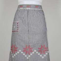 Front view of black and whit gingham apron on mannequin.