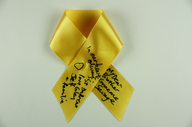 Yellow ribbon with black text.