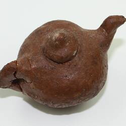 Clay toy teapot, viewed from above.