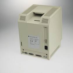 Back of square, box-like, beige plastic unit with 9 inch screen at front and 3 1/2 inch floppy disc drive below.