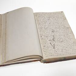 Open book with two pages of handwritten cursive text in ink.
