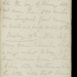Open diary with handwritten text on discoloured worn page.