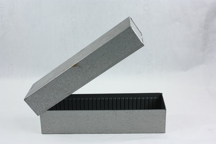 Rectangular metal box with inner metal dividers.