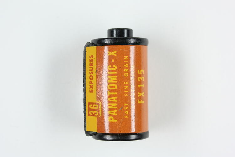 Cylindrical cartridge with orange, pressed metal label.