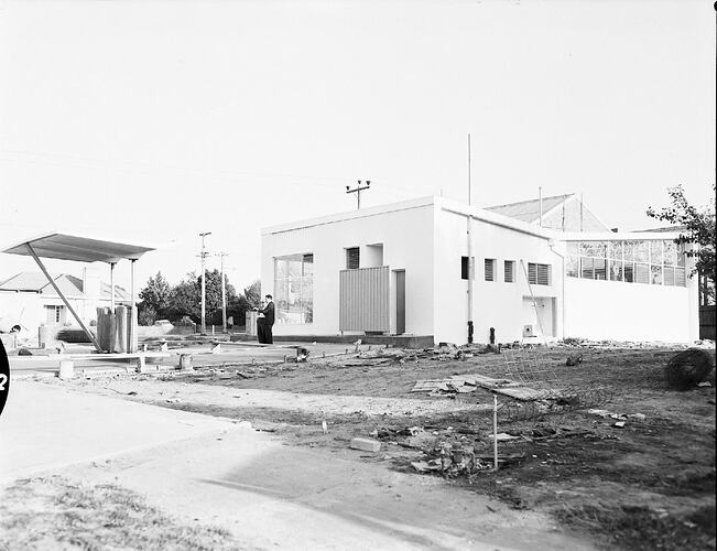 Monochrome photograph of a petrol station.