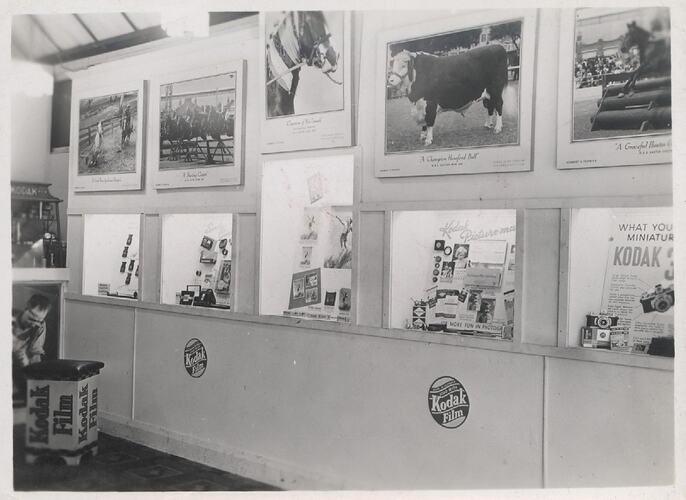Shop wall with product displays and photographs.