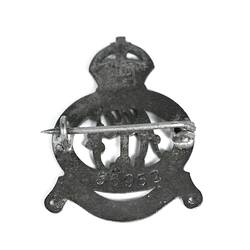 Back of silver badge with fastening pin