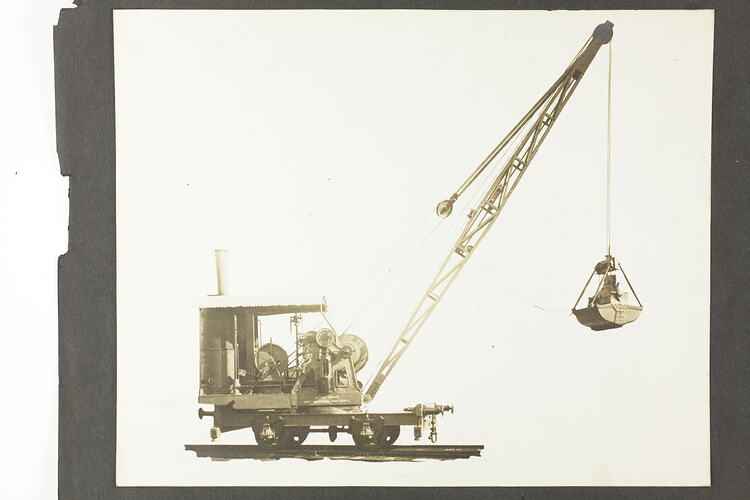Monochrome photograph of an excavator.
