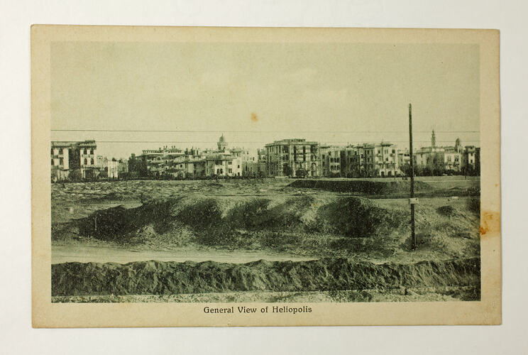 Front of postcard with photo of town.