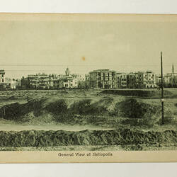 Front of postcard with photo of town.