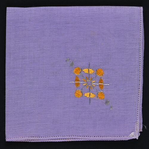 Folded Lavender Linen handkerchief with Embroidered Motif.
