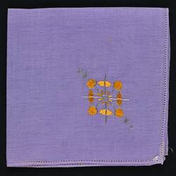 Folded Lavender Linen handkerchief with Embroidered Motif.