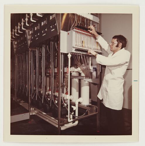Slide 511, 'Extra Prints of Coburg Lecture', Worker Adjusting Film Reel on Processing Equipment, Kodak Factory, Coburg, circa 1960s