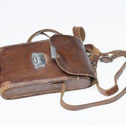 Brown leather camera carry case with shoulder strap.