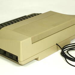 Three quarter view of beige plastic unit with keyboard.