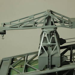 Detail of crane on top of grey plastic mining machine.