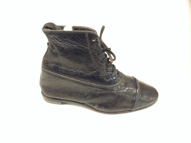 Miniature hand sewn black boot.