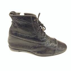 Miniature hand sewn black boot.