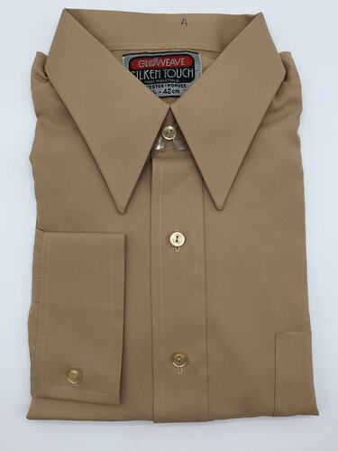 Brown folded collared shirt with buttons.