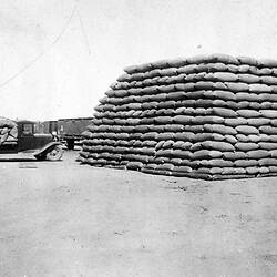 Negative - Delivering Grain Harvest by Motor Truck to Wheat Stacks at Thurla Railway Station, Millewa District, Victoria, 1931