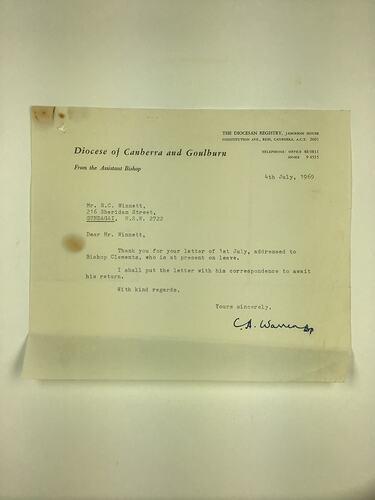 Off-white page with typewritten text. Signed lower right corner.