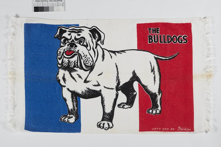 Cotton tea towel featuring bulldog with blue, white and red stripe behind.