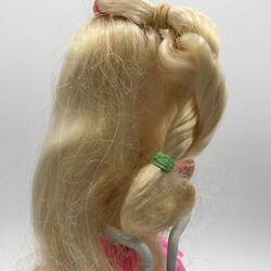 Detail of Barbie doll's long blonde twirled hair.