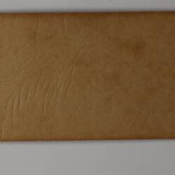 Back of off-white rectangular label.