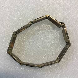 Bracelet made of hand-made silver links, each with tortoiseshell insets. Closed.