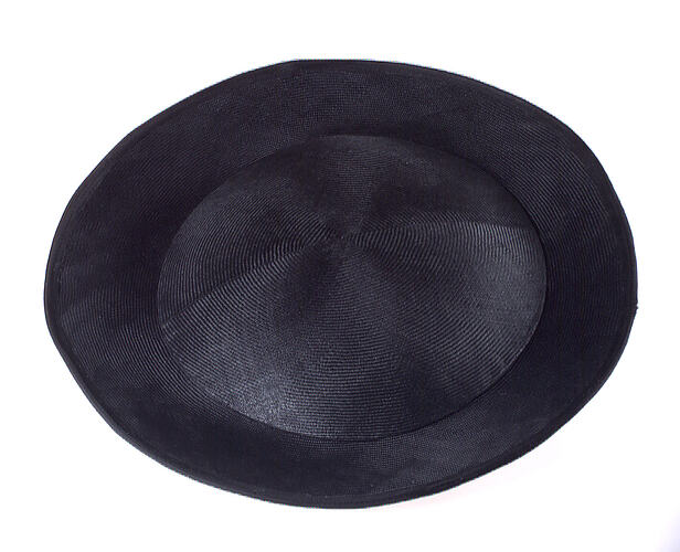 Round black straw hat with flat crown and shallow upturned brim.