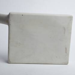 White rectangular ceramic container with cylindrical spout/opening at top left.