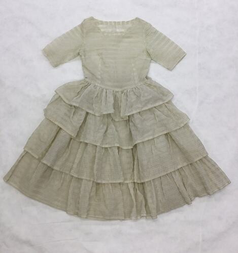 Short sleeve, round neck, cream dress with fine gold horizontal stripes. Four frilled layer skirt.