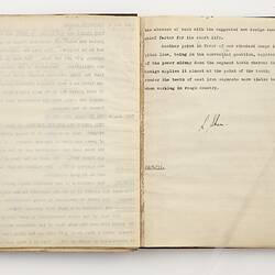 Open book with off white pages. Typed text on right side.