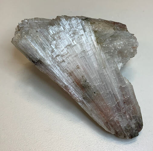 Clear, glass-like crystal with striations.