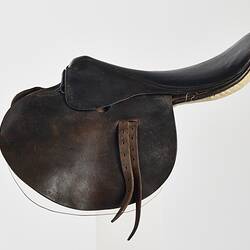 Brown leather horse riding saddle.