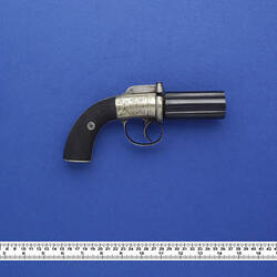 Small six barrelled revolver.