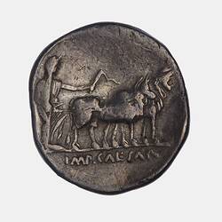Round coin with male ploughing with a pair of oxen to right.