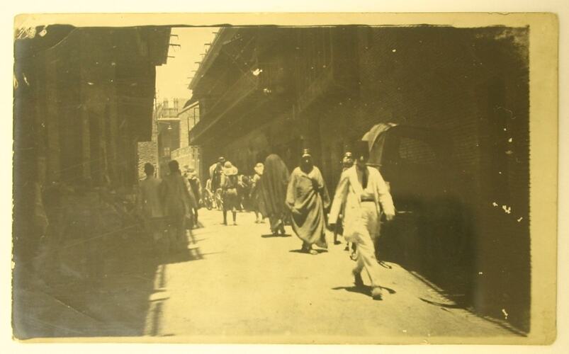People walking down a street in Basra.