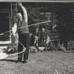 Digital Photograph - Holden Brothers Circus, Man 'spins' Two Ropes on Front Lawn, Kensington, late 1950s