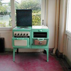 Green and cream old fashioned electric stove in a house.