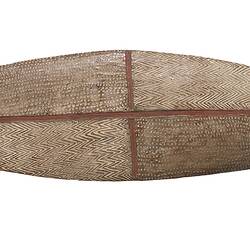 Wooden shield with pointed ends and incised decorations.