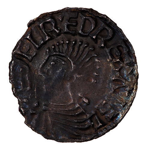 Coin, round, bust of the King wearing armour facing left, the base of the bust reaches the edge of the coin.