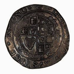 Coin, round, at centre within a circle of beads; garnished oval shield quartered with royal arms; text around.